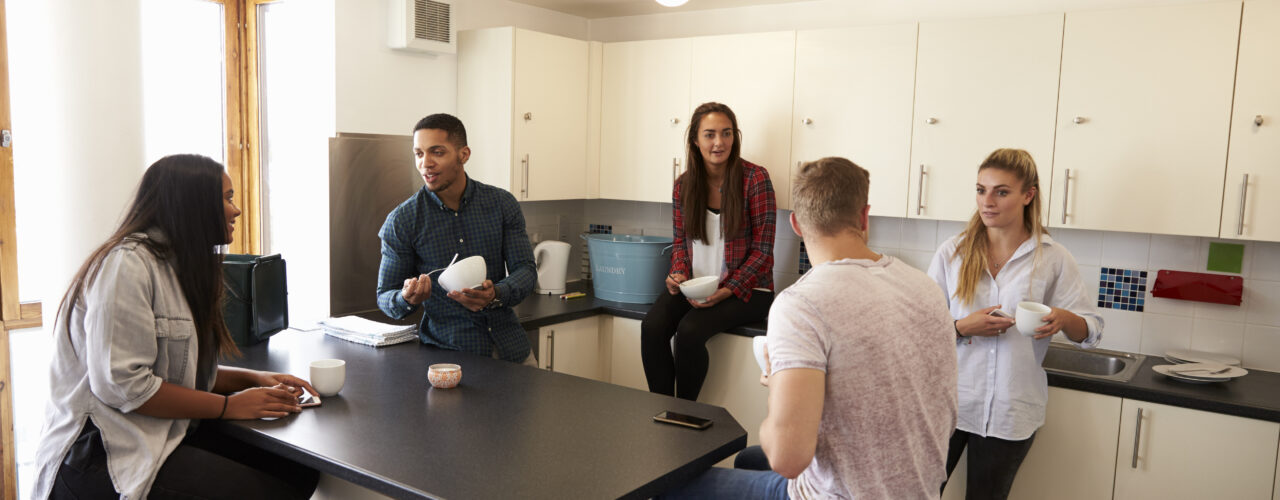 Flat mates in a shared kitchen.