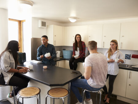 Flat mates in a shared kitchen.