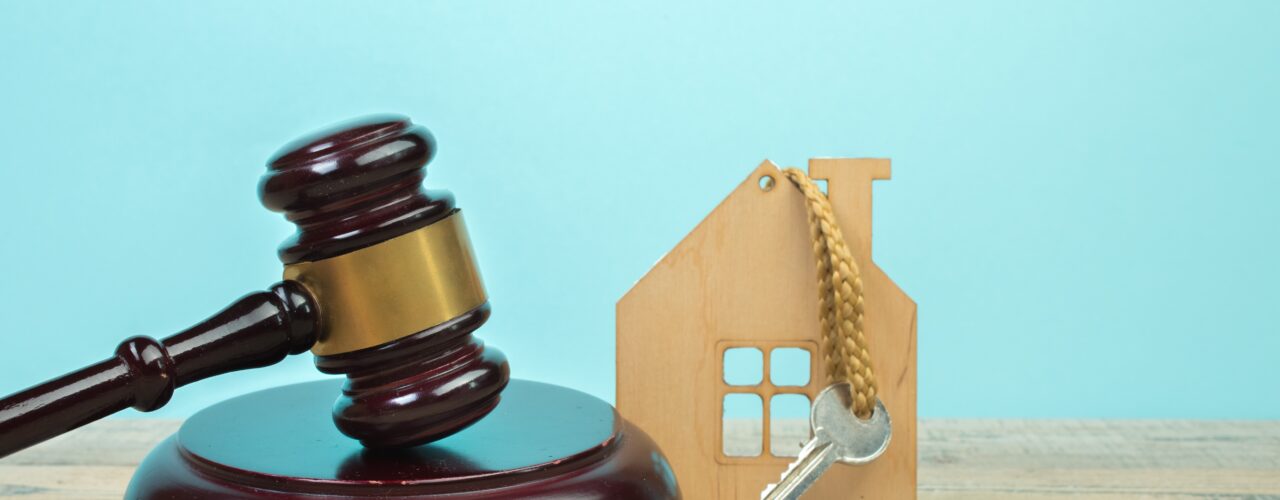 An image of a gavel and a house key.
