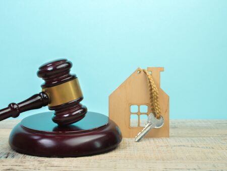 An image of a gavel and a house key.