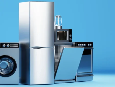 Kitchen appliances such as a fridge, oven and dishwasher with a blue background