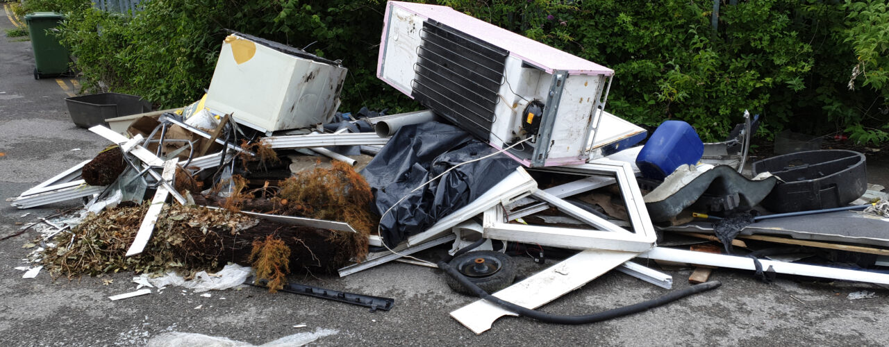 Household appliances being tipped in the road