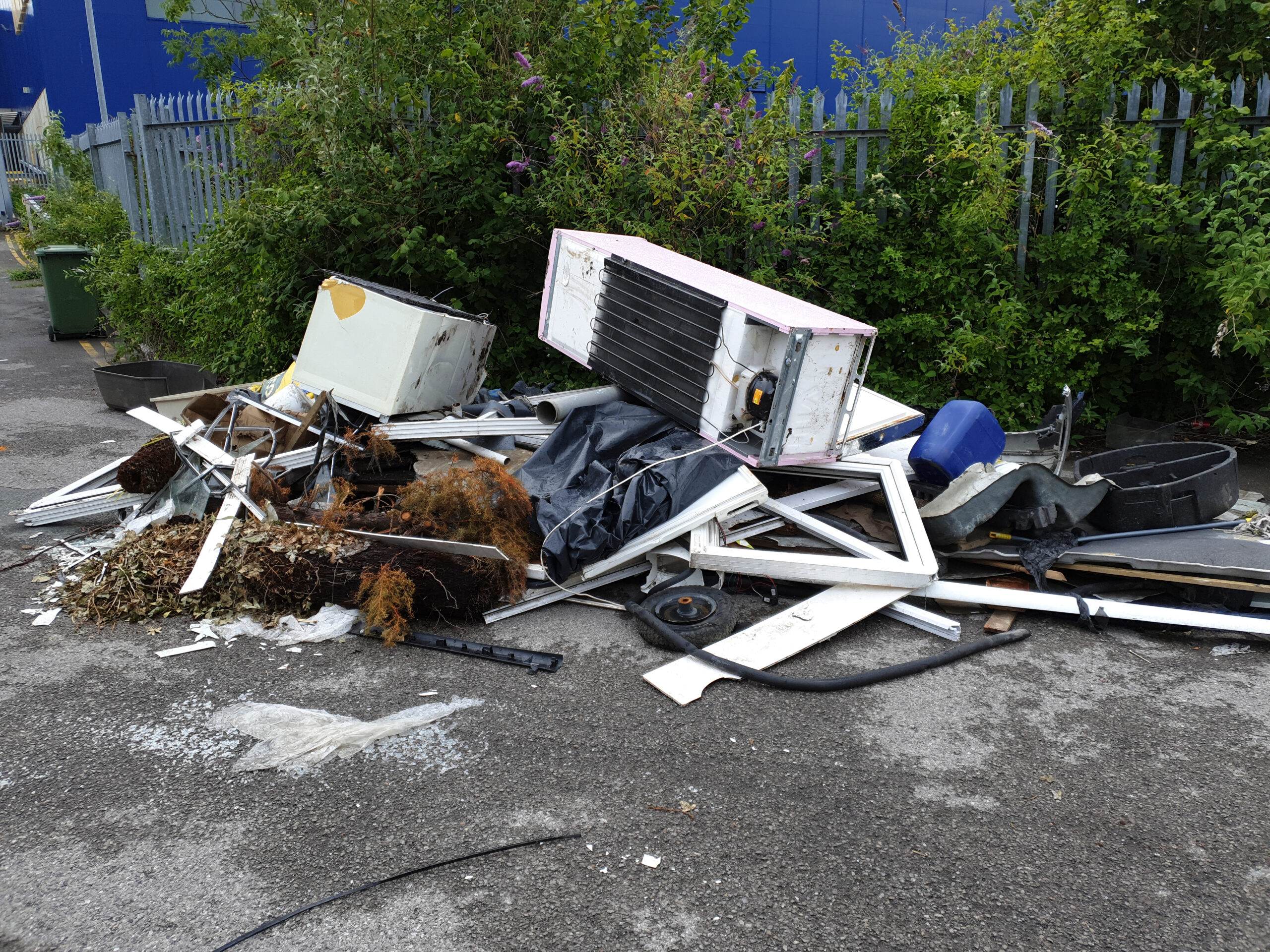 Household appliances being tipped in the road