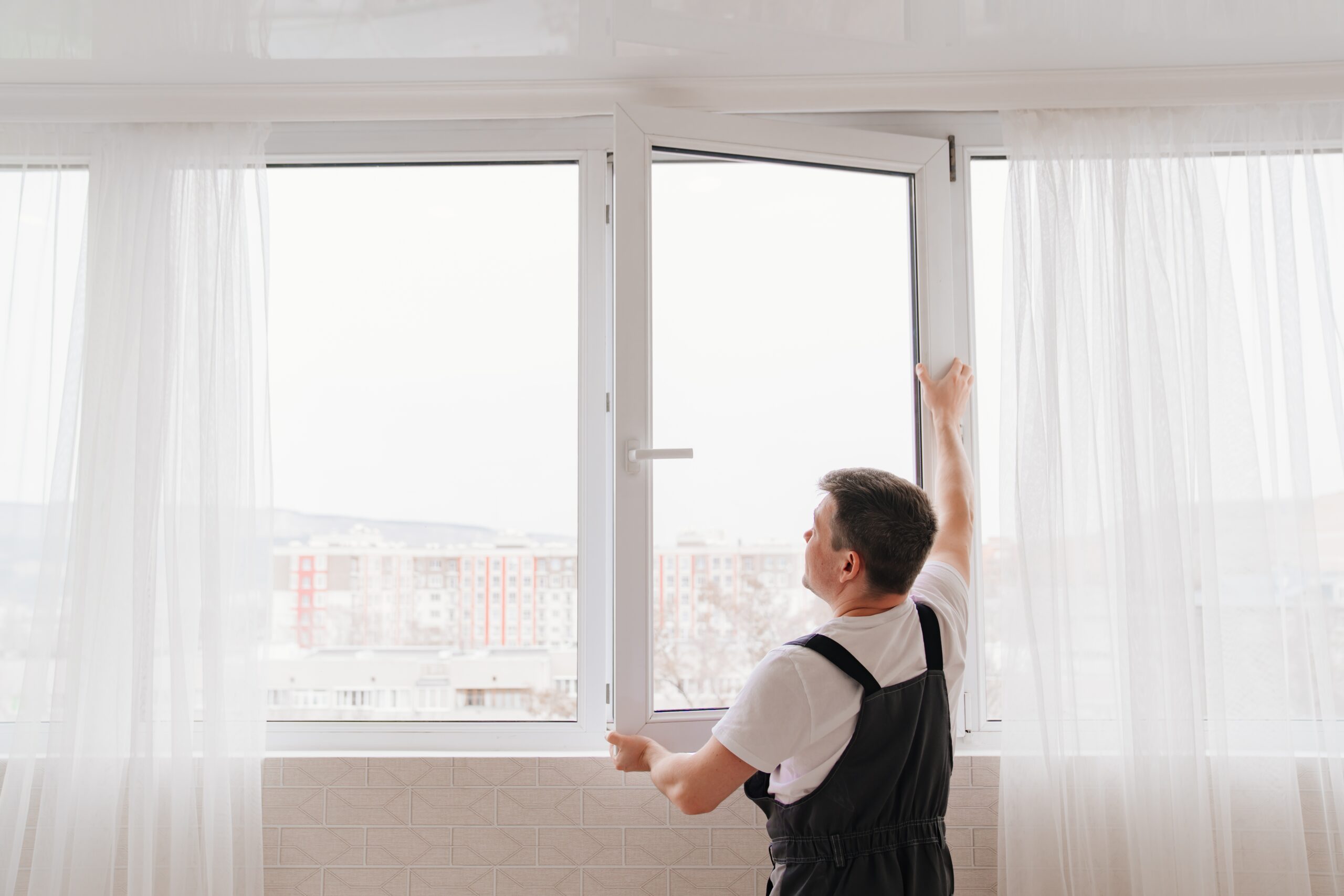 A repairman fitting windows