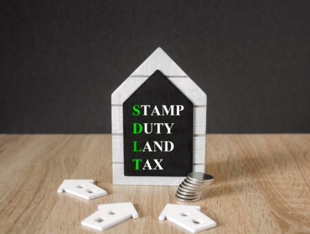 A model shaped as a house with 'Stamp duty land tax'