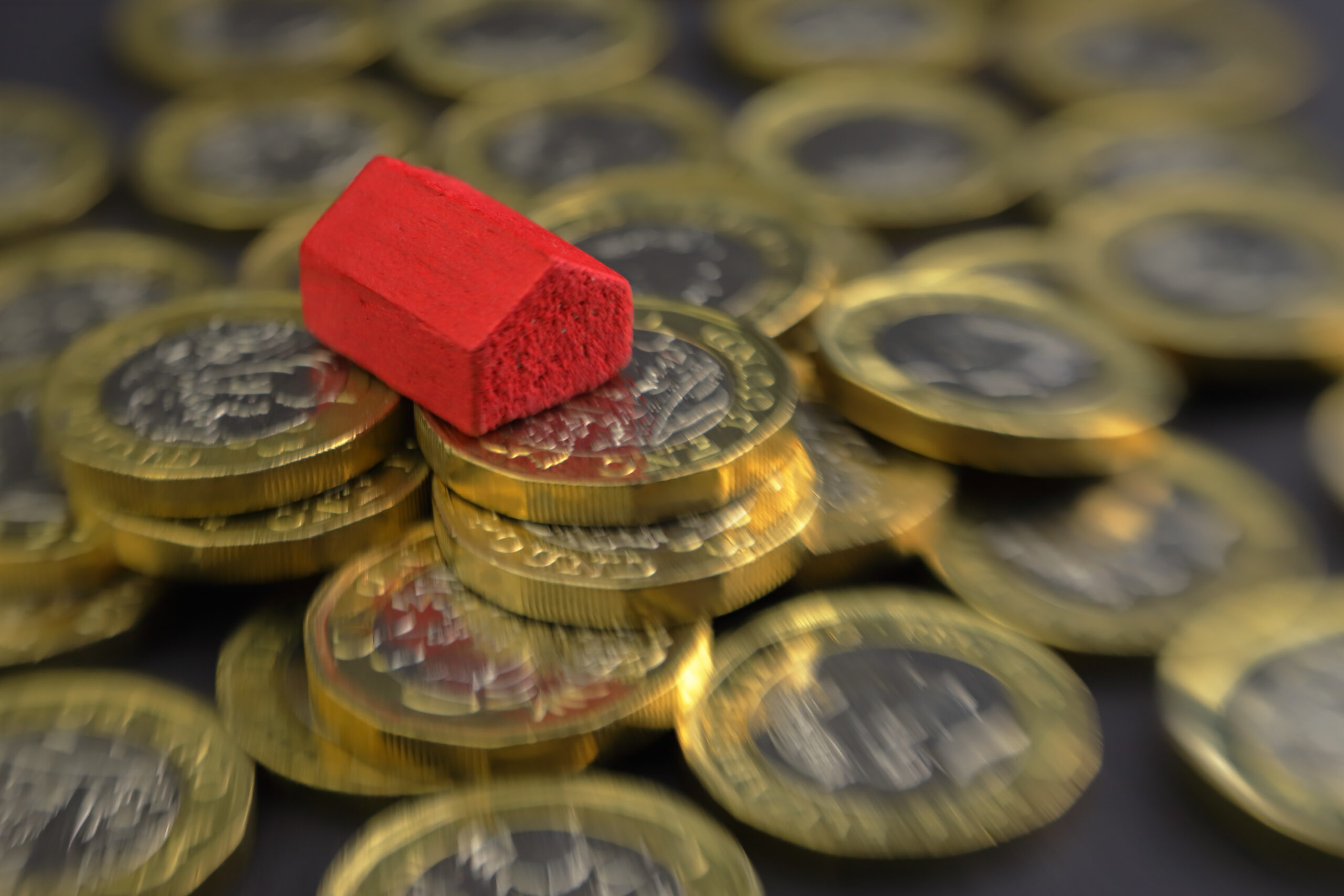 coins with a model of a house on top