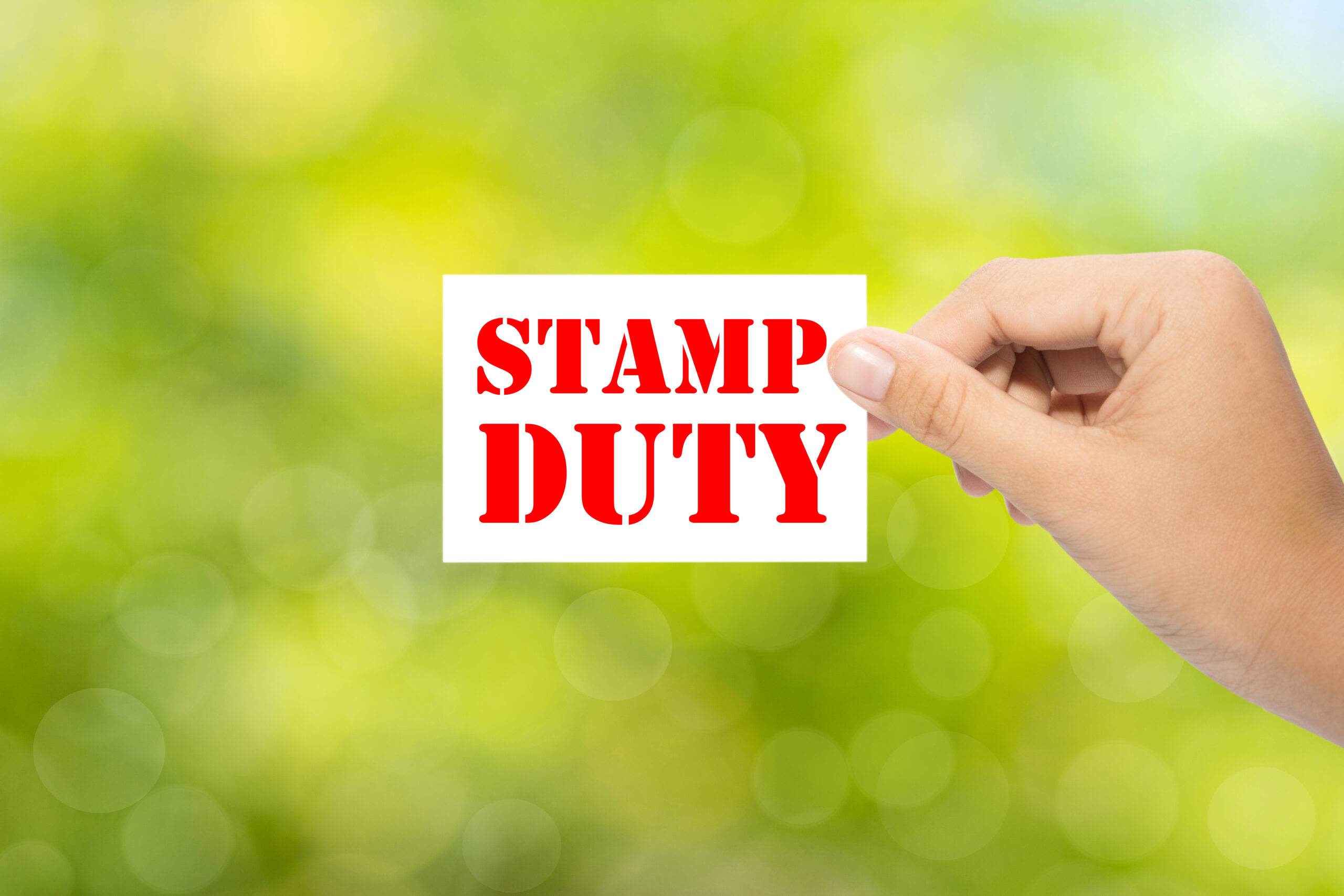 Someone holding a 'stamp duty' sign