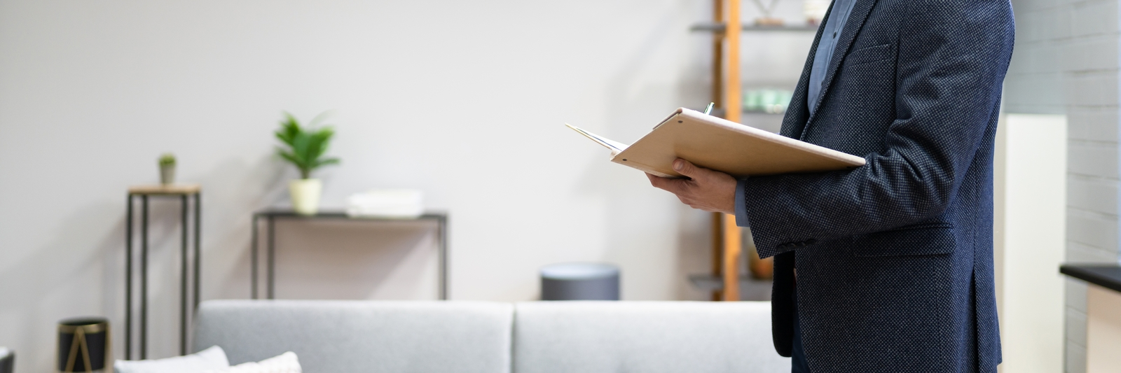 A man with a clipboard doing an inspection of a HMO property.