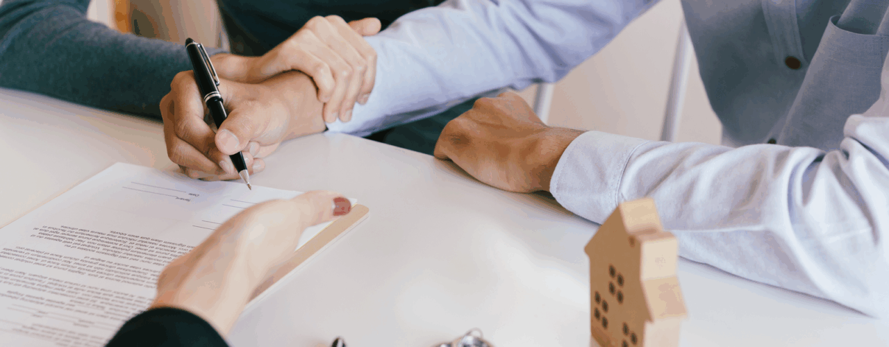 A landlord signing the forms to change letting agents.