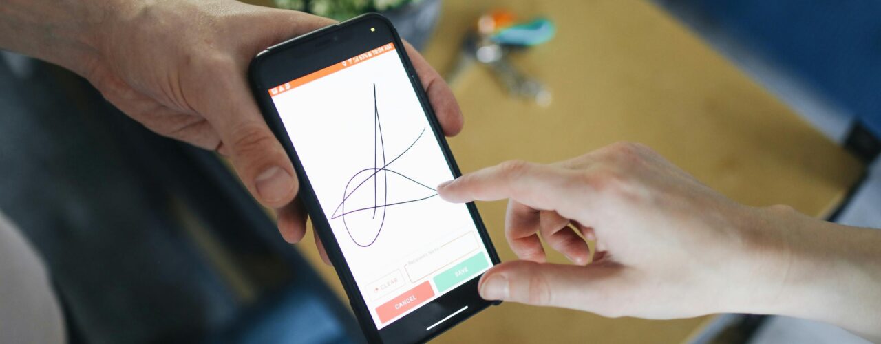 An image of someone signing their signature electronically