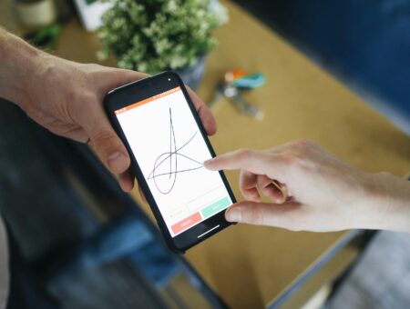 An image of someone signing their signature electronically