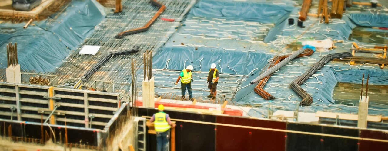 An image of scaffolding and builders on a building site.