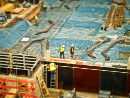 An image of scaffolding and builders on a building site.