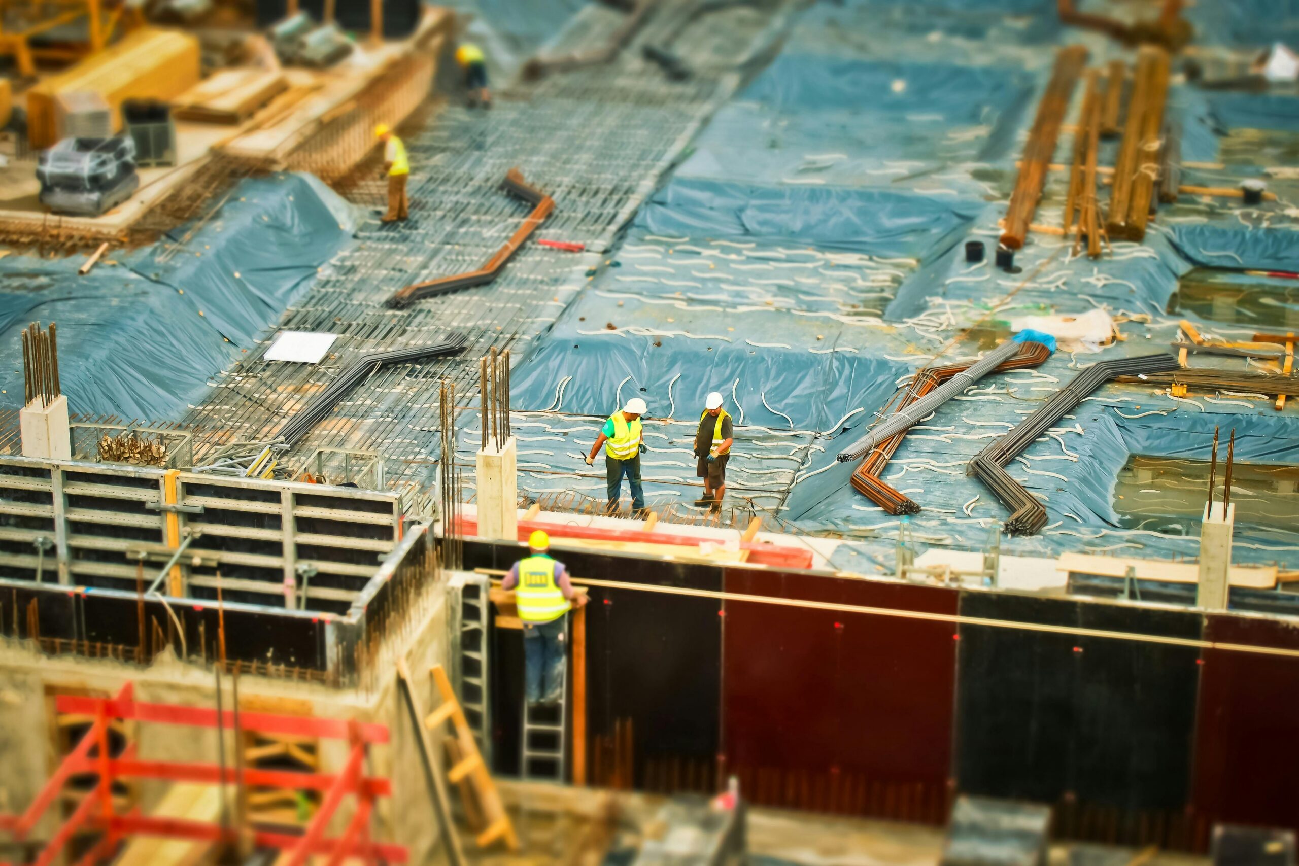 An image of scaffolding and builders on a building site.