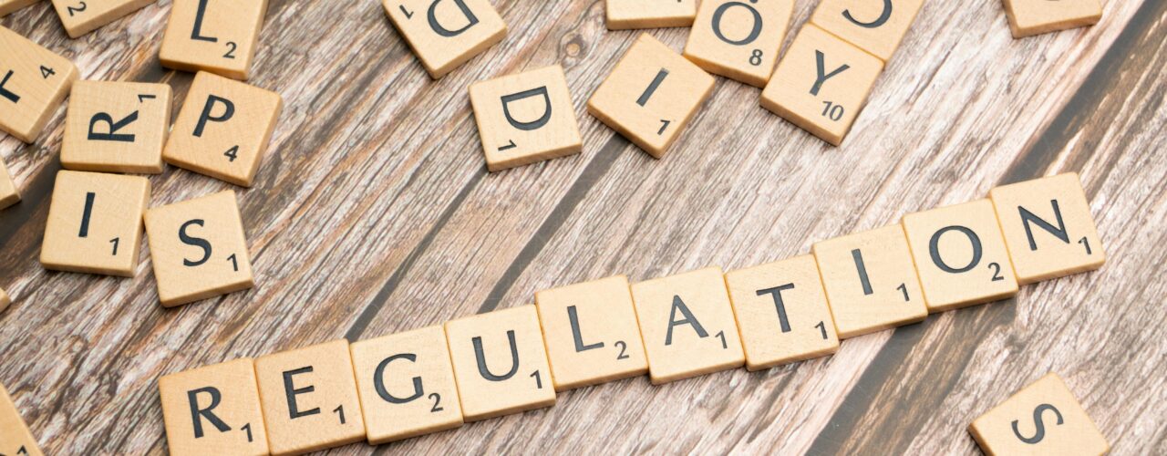 Scrabble tiles spelling the word 'regulation'