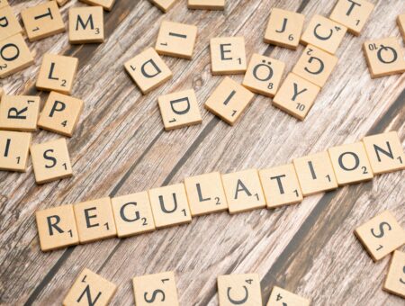 Scrabble tiles spelling the word 'regulation'