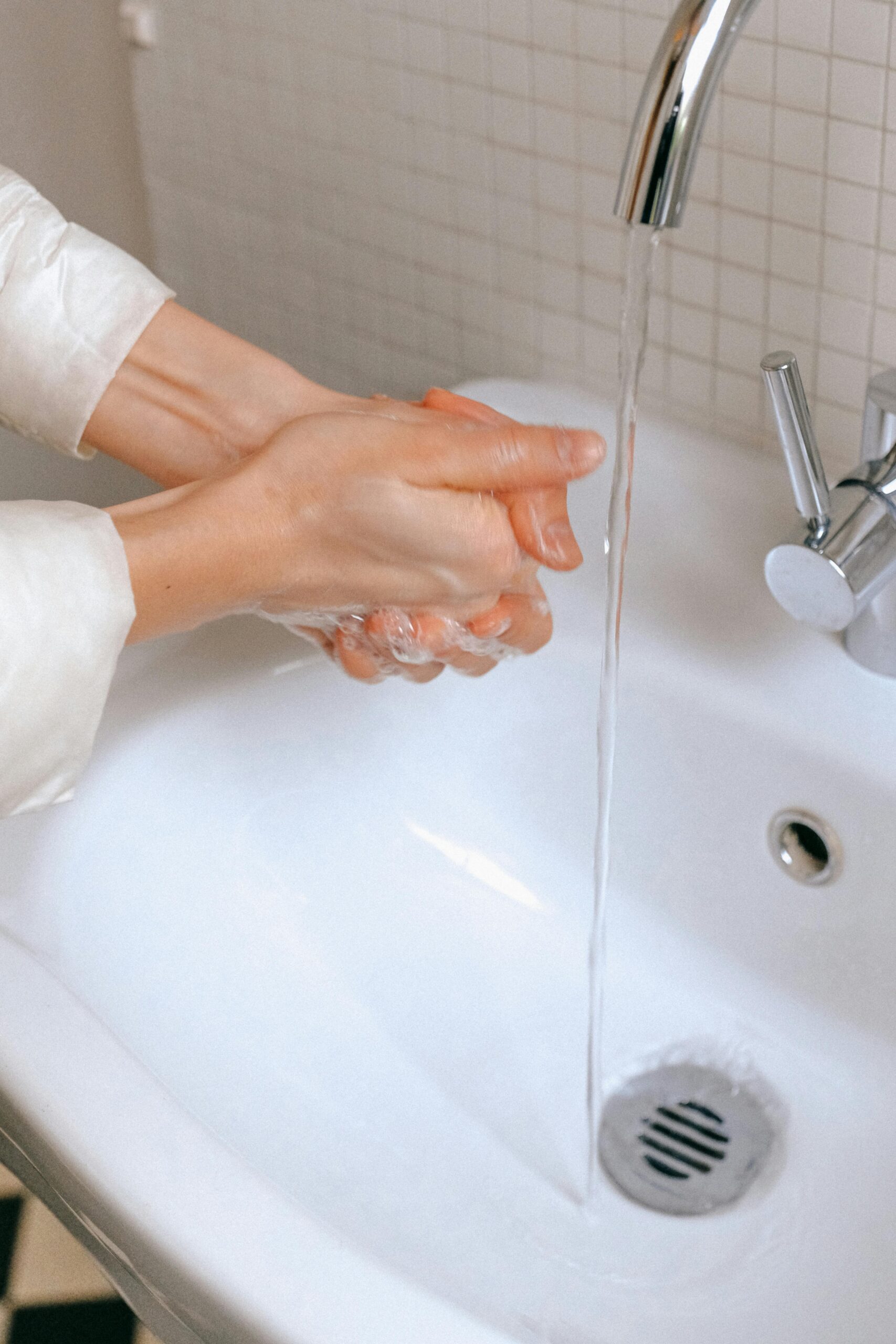 A women washing her hands in a basin