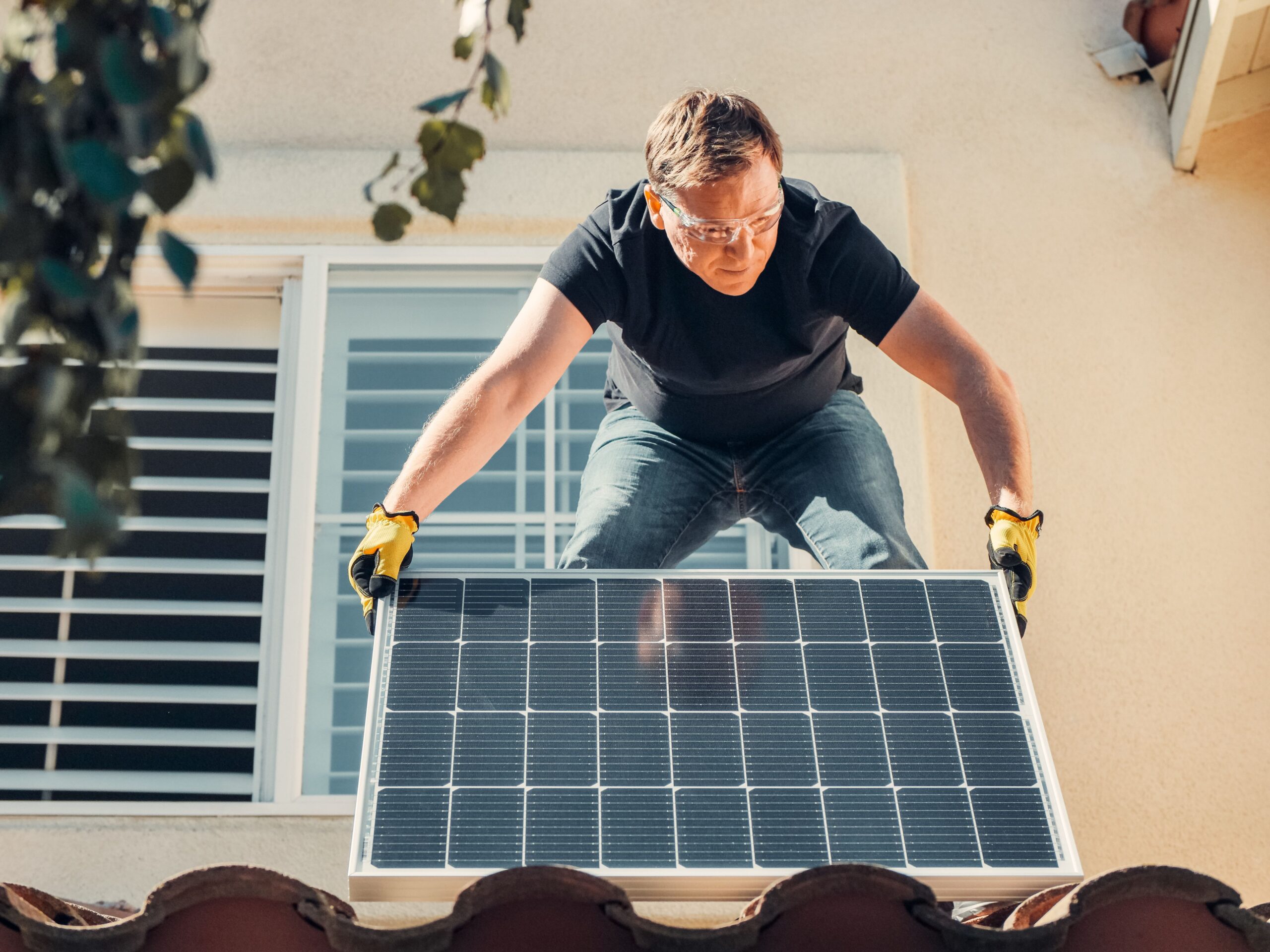 A man installing solar panels in a rental property